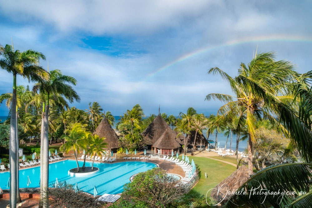 Rainbow at the a tropical beach resort in New Caledonia